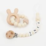 Conjunto chupetero personalizado y mordedor silicona MOMMA Beige. Sujetachupete silicona de grado alimentario libre de BPA, PVC, Ftalatos, cadmio y plomo. Pinza de madera y cordón de nylon de alta resistencia,bajo normativa europea EN12586:2007 (A1:2011) Mordedor de silicona de grado alimentario libre de BPA, PVC, Ftalatos, cadmio y plomo. Cordón de nylon de alta resistencia,bajo normativa europea EN12586:2007 (A1:2011) con figura de madera.