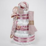 Tarta de pañales de 3 pisos compuesto por 52 unidades marca Dodot sensitive, pelota sensorial Montessori de Little Dutch, mordedor orejitas de tela piqué waffle algodón y aro de madera natural personalizado con el nombre del bebé, bandana de tela piqué waffle algodón personalizable, chupetero de silicona y crochet con pinza de madera natural de haya, paño de lactancia de piqué waffle algodón, muñeca ANNA de Little Dutch 35cm. Stick de madera personalizado con el nombre del bebé. Dimensiones altura 42cm x 27cm ancho. Color Rosa palo