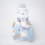 Regalo original para bebé Tarta de pañales Sweet Cake de tres pisos compuesto por 52 unidades marca Dodot sensitive T2, peluche principal conejito personalizado, sujeta chupetes de silicona personalizable, mordedor orejitas piqué waffle algodón y madera personalizado, cepillo para bebé de madera 100% natural personalizado, mordedor de silicona y bandana de piqué waffle personalizable. Dimensiones altura 55cm x 26cm ancho. Color Azul